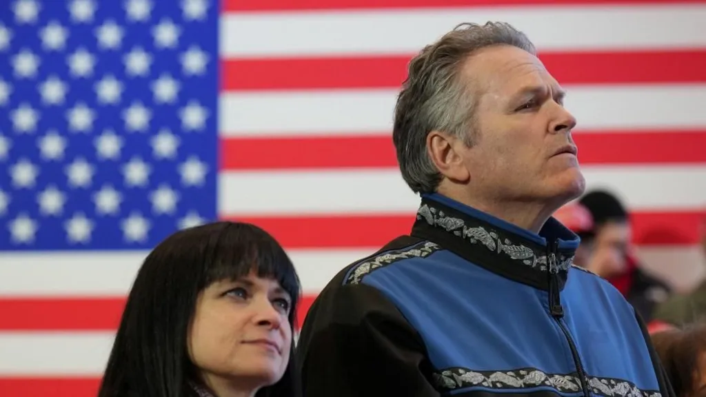Reuters File image of Governor Mike Dunleavy standing in front of a US flag at an event