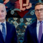 AFP via Getty Images Norway's Prime Minister Jonas Gahr Støre (L) and Finnish President Alexander Stubb wearing navy suits. Støre has a white shirt and blue tie, while Stubb has a white shirt, purple tie and black-rimmed glasses.