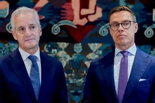 AFP via Getty Images Norway's Prime Minister Jonas Gahr Støre (L) and Finnish President Alexander Stubb wearing navy suits. Støre has a white shirt and blue tie, while Stubb has a white shirt, purple tie and black-rimmed glasses.