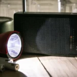 Getty Images A red torch shines a beam of light on a black portable radio.