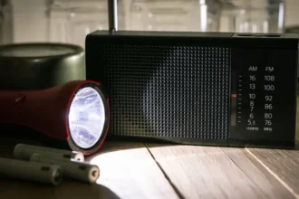 Getty Images A red torch shines a beam of light on a black portable radio.