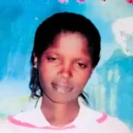 Rose Wanyua A young woman with dark skin smiling softly in a photo. Behind her is a large blue piece of wall