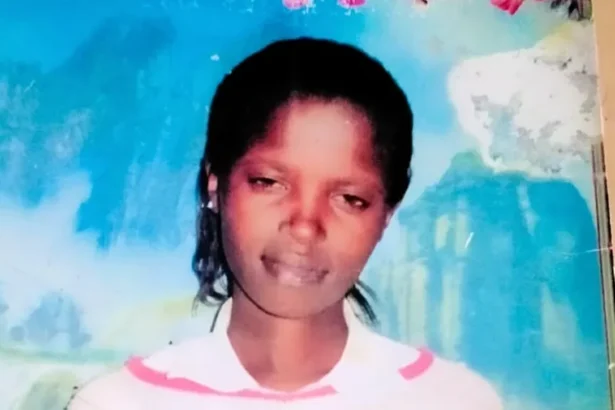 Rose Wanyua A young woman with dark skin smiling softly in a photo. Behind her is a large blue piece of wall