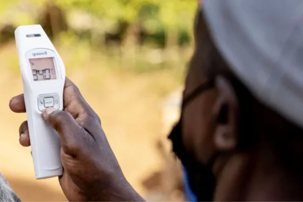 Getty Images An official takes a temperature as part of Ebola preventative measures in East Africa.