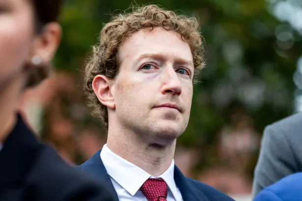 EPA Meta CEO Mark Zuckerberg standing outside of the White House, looking to the side, while surrounded by security people.