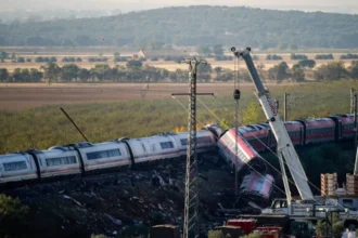 Reuters View of the two smashed trains near Toledo, Spain, 29 Oct 2026, with rescuers' cranes at scene and a plain and hills in background
