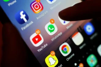 PA Icons of social media apps, including Facebook, Instagram, YouTube and WhatsApp, is displayed on a mobile phone screen. File photo