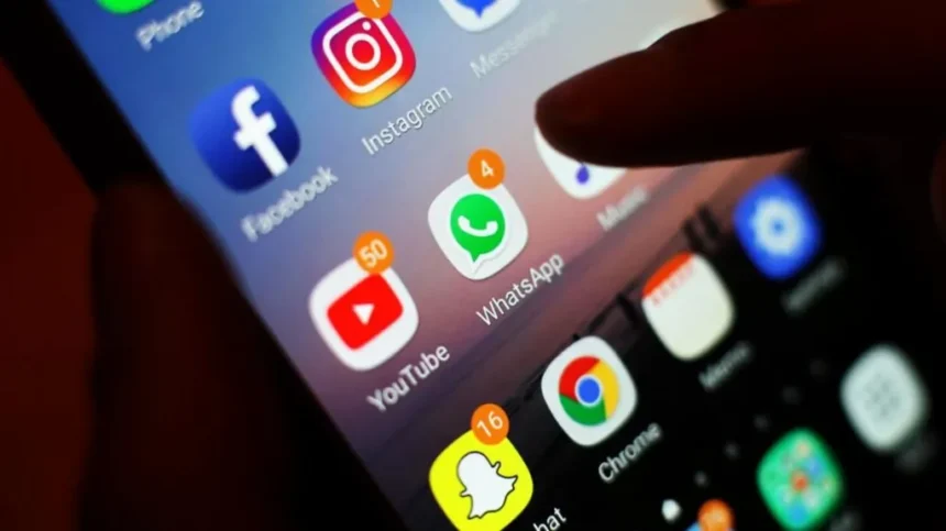 PA Icons of social media apps, including Facebook, Instagram, YouTube and WhatsApp, is displayed on a mobile phone screen. File photo
