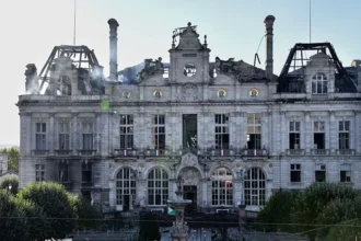 Getty Images This photograph shows the partially burnt facade of the Limoges city hall a day after riot and looting following nationwide protests against the "high cost of living", in Limoges on October 18, 2026.