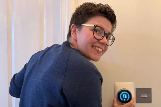 Cora Harrison Cora Harrison, a woman with short brown hair and glasses in a navy jumper, adjusts the temperature on a thermostat to 18 degrees
