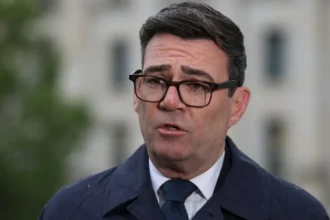 PA Media Prime Minister Andy Burnham speaks to the media following his meeting with German Chancellor Friedrich Merz at the Chancellery in Berlin, on 8 October 2026