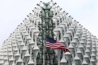 PA Images The exterior of the US Embassy in London with an American flag flying in front of the nearest corner, in the centre of the image.