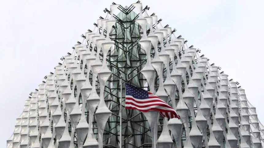 PA Images The exterior of the US Embassy in London with an American flag flying in front of the nearest corner, in the centre of the image.