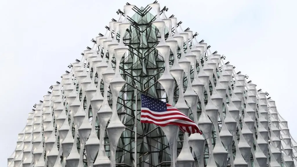 PA Images The exterior of the US Embassy in London with an American flag flying in front of the nearest corner, in the centre of the image.
