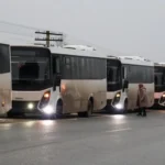Reuters A row of white coaches are parked up on the side of the road