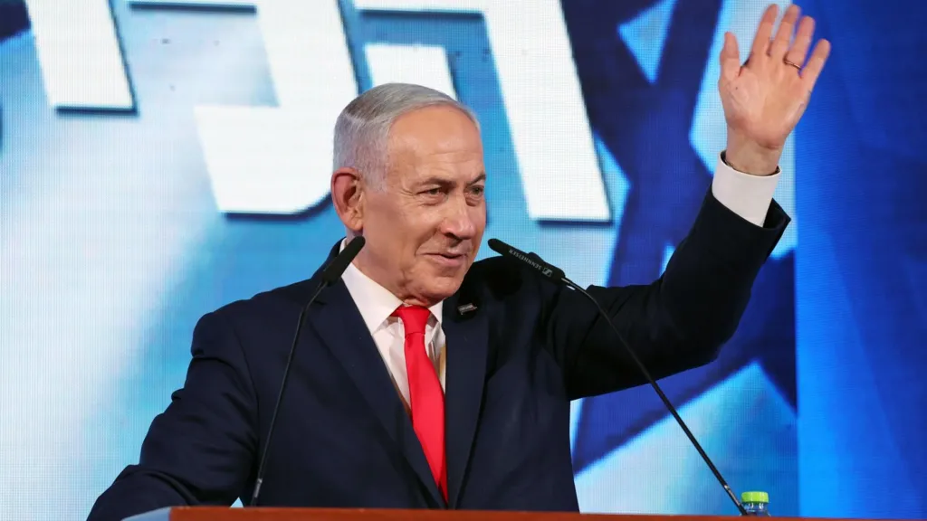 EPA Israeli Prime Minister Benjamin Netanyahu waves while addressing supporters at his Likud party's headquarters in Jerusalem (28 October 2026)