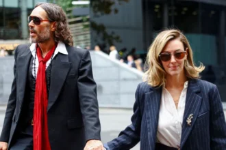 Reuters Russell Brand and Laura Brand holding hands and walking into court on Thursday