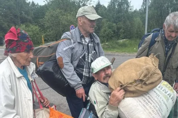 Ksenia Arkhipova Four people carrying belongings leave Oleshky, Ukraine's southern city occupied by Russia