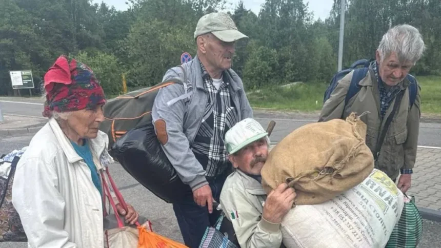 Ksenia Arkhipova Four people carrying belongings leave Oleshky, Ukraine's southern city occupied by Russia