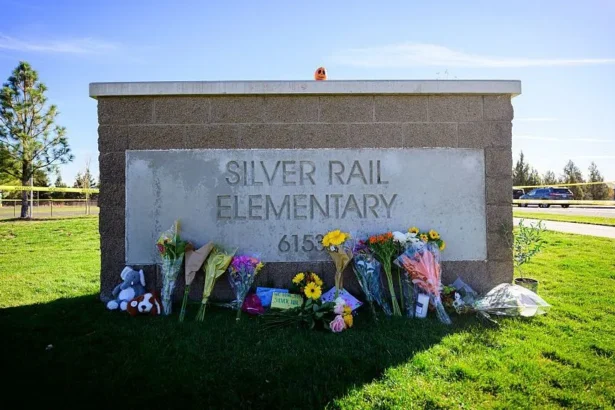 Getty Images Flowers lay against the entry sign of Silver Rail Elementary School on October 16, 2026 in Bend, Oregon.