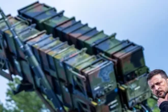 EPA-EFE/REX/Shutterstock Ukrainian President Volodymyr Zelensky stands in front of a US-made Patriot anti-aircraft missile system. File photo