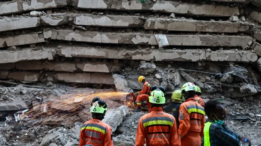 EPA An emergency worker saws through metal and concrete as others watch on at the site of a building collapse in Nairobi.
