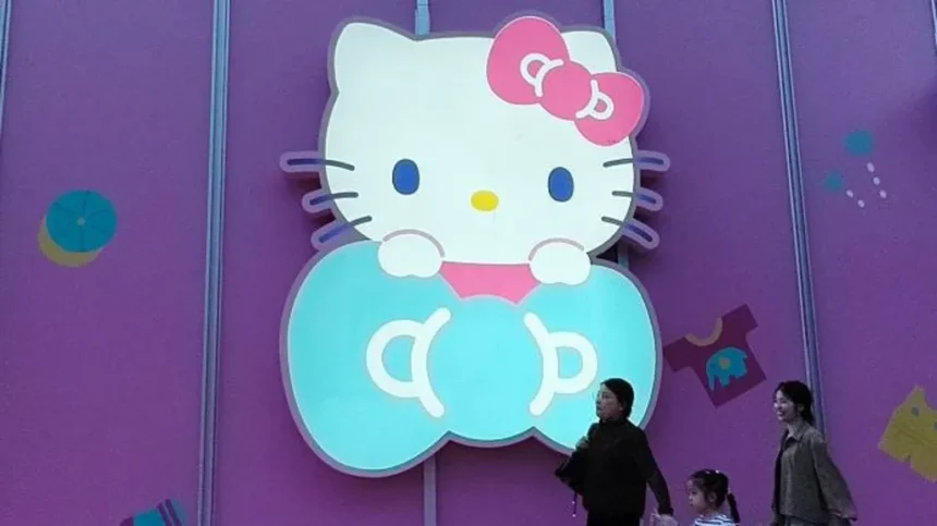 Getty Images Three women walk past a big glowing Hello Kitty signage on a purple store wall in Shanghai, China