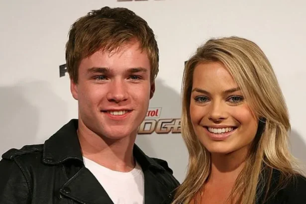 Getty A young man with short brown hair and a woman with long blonde hair smile at the camera