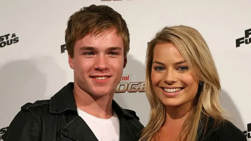 Getty A young man with short brown hair and a woman with long blonde hair smile at the camera