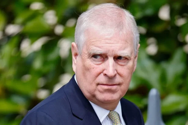 Getty Images A shot of Andrew Mountbatten-Windsor from the shoulders up. He is wearing a navy suit with a white shirt and a patterned tie. He is looking to the side. The background is blurred.