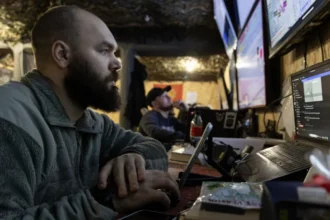 Getty Images A close up of a Ukranian soldier surrounded by computer screens