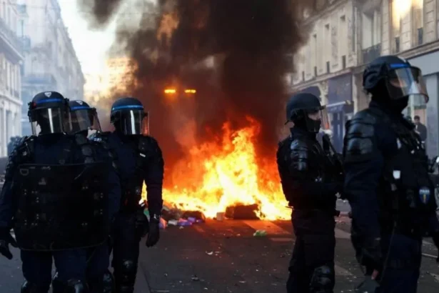 Reuters Riot police near a fire in a Paris street