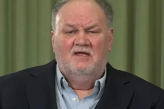 ITV/Shutterstock Thomas Markle, an older white man with grey hair and a short white beard. He is wearing a dark blue suit jacket and light blue shirt.