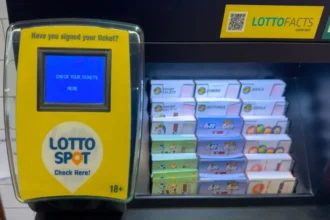 Getty Images Lotto Spot ticket checker and lottery scratch card display in a retail store