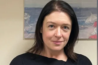Wiltshire Police/PA Media Head and shoulders image of Joanne Young in a black top. She has black hair and is smiling. She is standing in a room in front of a painting.