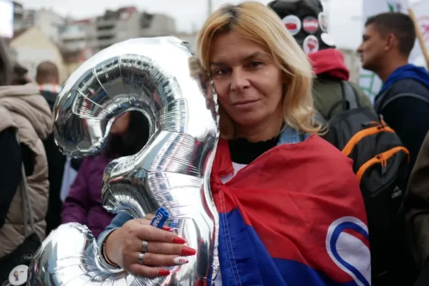 Guy Delauney/BBC A supporter with the figure 3 which represents the electoral list "Student List - Students Win" attends a final campaign rally in Belgrade, Serbia, October 22, 2026.