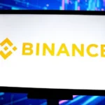 Getty Images A tablet with a white background and the yellow Binance logo on it against a blue background