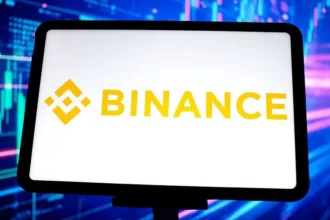Getty Images A tablet with a white background and the yellow Binance logo on it against a blue background
