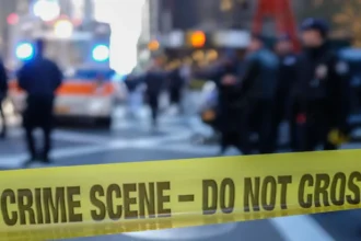 Getty Images Police sealing off a US city street with yellow tape reading "crime scene - do not cross".