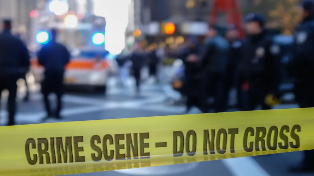 c84f3960-c16c-11f1-babe-4199b0e7ccea-jpg Getty Images Police sealing off a US city street with yellow tape reading "crime scene - do not cross".