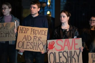 Getty Images Activists hold placards with slogans during a rally in support of residents of Oleshky, Kherson region, calling on the international community to draw attention to the humanitarian situation in the Russian-occupied city.