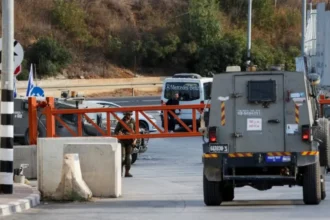 Reuters An Israeli army vehicle passes near the closed entrance of Hebron, in the Israeli-occupied West Bank