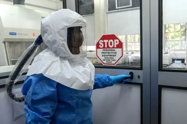 AFP via Getty Images A laboratory technologist wearing protective equipment as she prepares to enter the Viral Hemorrhagic Fever Laboratory at Uganda Virus Research Institute in Entebbe, Uganda