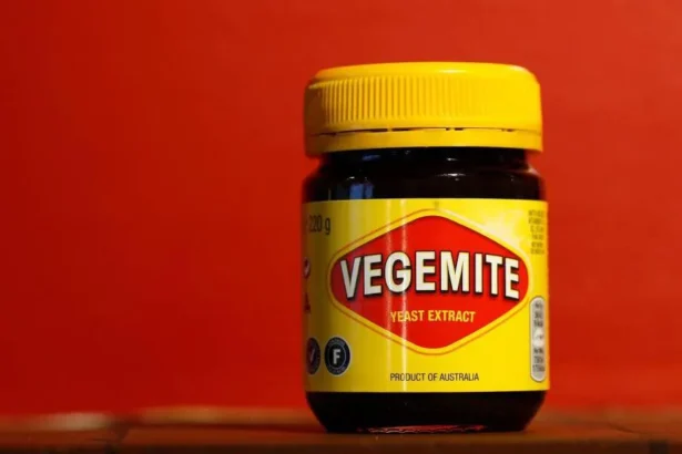 Getty Images A yellow jar of Vegemite on a shelf, with a red background
