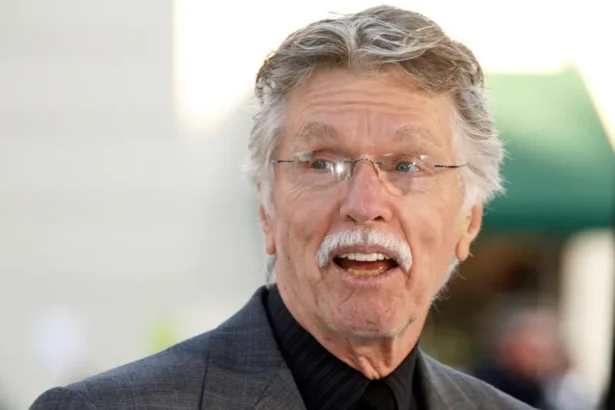 REUTERS/Fred Prouser/File Photo Actor Tom Skerritt is seen with his mouth open, apparently talking, and smiling. He is wearing a black buttoned-up shirt, rimless glasses and a grey suit coat. He appears to be outside.
