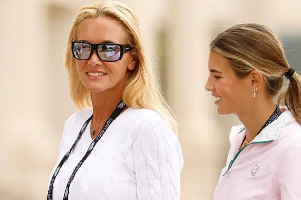 Getty Images Vanessa, in sunglasses and a white sweater, with a slight smile, and Kai Trump, in a pale pink golf shirt, walking beside each other, at a golf championship event