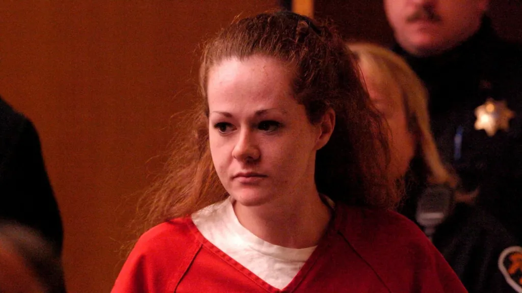 Reuters Christa Pike, a woman with red hair wears a white top with a red top on top