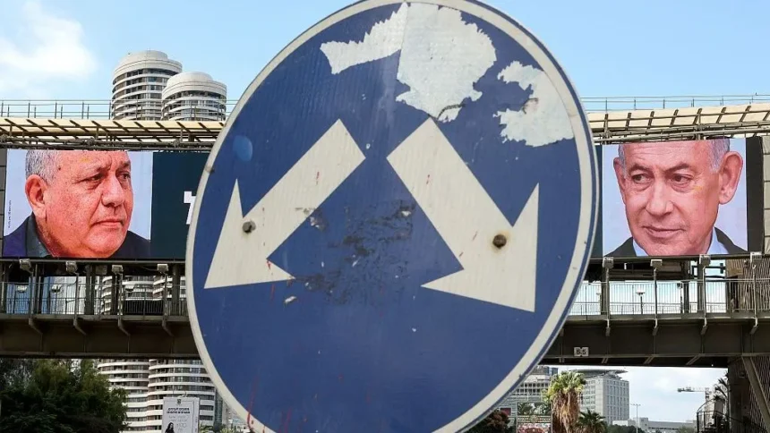 AFP via Getty Images A street sign points at billboards for Eisenkot and Netanyahu.