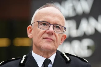 PA Media Metropolitan Police Commissioner Sir Mark Rowley stands in front of the New Scotland Yard sign, his head and shoulders in shot