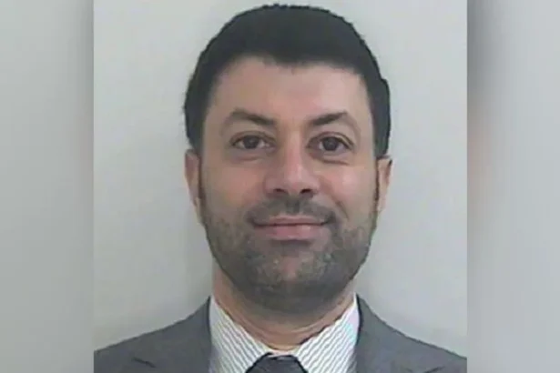 HMRC Image shows a Passport-style photo of Arif Patel, who has short dark hair, a short dark beard, and is wearing a grey suit with a grey and white striped shirt and grey tie.